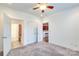 Bedroom featuring carpet, a ceiling fan and access to the bathroom and kitchen at 1000 E Woodlawn Rd # 110, Charlotte, NC 28209