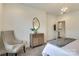 Bedroom featuring a stylish chair, side table and accents in neutral tones at 1000 E Woodlawn Rd # 110, Charlotte, NC 28209