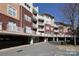 Apartment complex with underground garage; units feature private balconies with white railings at 1000 E Woodlawn Rd # 110, Charlotte, NC 28209