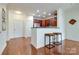 Kitchen and breakfast bar featuring wood floors, cherry cabinets, and stainless appliances at 1000 E Woodlawn Rd # 110, Charlotte, NC 28209