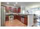 Stylish kitchen features stainless steel appliances, granite counters, and cherry wood cabinets at 1000 E Woodlawn Rd # 110, Charlotte, NC 28209