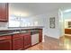 Kitchen sink with stainless appliances with view to dining and living area at 1000 E Woodlawn Rd # 110, Charlotte, NC 28209