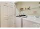 Efficient laundry area with a modern washer and dryer set and convenient overhead shelving at 1000 E Woodlawn Rd # 110, Charlotte, NC 28209