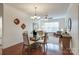 Open-concept living and dining area with hardwood floors, a ceiling fan, and modern lighting at 1000 E Woodlawn Rd # 110, Charlotte, NC 28209