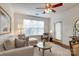 Bright living room with hardwood floors, a modern sofa, ceiling fan, and lots of natural light at 1000 E Woodlawn Rd # 110, Charlotte, NC 28209