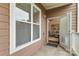 Inviting porch view through an open door into a warm, neutrally decorated living space at 1000 E Woodlawn Rd # 110, Charlotte, NC 28209