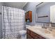Bathroom with cabinet storage, shower with curtain and tile flooring at 1008 Newton Ave, Rock Hill, SC 29732
