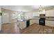 Eat-in kitchen with white cabinets, modern appliances, and hardwood floors at 1008 Newton Ave, Rock Hill, SC 29732
