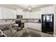 Modern kitchen with white cabinets, black countertops, and stainless steel appliances at 1008 Newton Ave, Rock Hill, SC 29732
