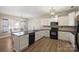 Eat-in kitchen with white cabinets, modern appliances, and hardwood floors at 1008 Newton Ave, Rock Hill, SC 29732