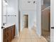 A well-lit bathroom featuring a shower, tub, vanity, and tile floors at 1016 Filly Dr, Indian Trail, NC 28079