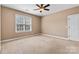 Neutral bedroom with a ceiling fan, a window with blinds, and neutral carpet at 1016 Filly Dr, Indian Trail, NC 28079