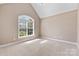 Neutral bedroom featuring a large window for natural light and plush carpeting at 1016 Filly Dr, Indian Trail, NC 28079