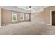 Large bedroom with three bright windows providing natural light and plush carpet at 1016 Filly Dr, Indian Trail, NC 28079