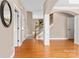 Foyer with hardwood floors leading to staircase with decorative molding and a glimpse of a fireplace at 1016 Filly Dr, Indian Trail, NC 28079