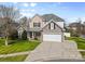 Charming two-story home features a well-manicured lawn, attached two car garage and inviting stone facade at 1016 Filly Dr, Indian Trail, NC 28079