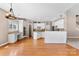 Bright kitchen with white cabinetry, granite countertops, stainless steel appliances, and hardwood flooring at 1016 Filly Dr, Indian Trail, NC 28079