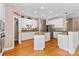 Modern kitchen featuring white cabinets, granite countertops, hardwood floors, and stainless steel refrigerator at 1016 Filly Dr, Indian Trail, NC 28079