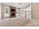 Inviting living room featuring a stone fireplace, multiple windows and an open floor plan at 1016 Filly Dr, Indian Trail, NC 28079
