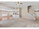 Open concept living space with hardwood floors, stairs, and a kitchen view at 1016 Filly Dr, Indian Trail, NC 28079