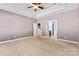 Comfortable main bedroom with tray ceiling and two doorways that lead to other rooms at 1016 Filly Dr, Indian Trail, NC 28079