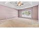 Spacious main bedroom with a tray ceiling and large window for natural light at 1016 Filly Dr, Indian Trail, NC 28079