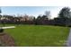 Large green grass backyard with a border of mulch with trees in the background at 106 Isle Of Pines Rd, Mooresville, NC 28117
