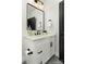 Modern bathroom vanity featuring a white countertop, black fixtures, and a sleek rectangular mirror at 106 Isle Of Pines Rd, Mooresville, NC 28117