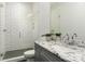 Modern bathroom featuring tiled shower, gray vanity with granite countertop, and a large mirror at 106 Isle Of Pines Rd, Mooresville, NC 28117