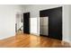 Bedroom featuring hardwood floors, stylish black doors and natural light at 106 Isle Of Pines Rd, Mooresville, NC 28117
