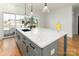 Kitchen island with a sleek faucet and countertop with a fruit bowl and lemon decor at 106 Isle Of Pines Rd, Mooresville, NC 28117