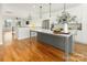 Bright, updated kitchen with gray island, modern appliances and wood floors at 106 Isle Of Pines Rd, Mooresville, NC 28117