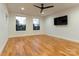 Modern living room with hardwood floors, large windows, and ample natural light at 106 Isle Of Pines Rd, Mooresville, NC 28117