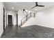 Open living space with dark tile floors, a modern staircase and recessed lighting at 106 Isle Of Pines Rd, Mooresville, NC 28117