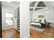 Bright main bedroom featuring a unique tray ceiling, walk-in closet and hardwood floors at 106 Isle Of Pines Rd, Mooresville, NC 28117