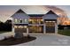 Modern farmhouse exterior with stone accents, two garage doors, and a welcoming front porch at 108 Isle Of Pines Rd # 3, Mooresville, NC 28117