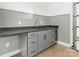 Garage wet bar with gray cabinetry, a mini fridge, and modern hardware at 108 Isle Of Pines Rd # 3, Mooresville, NC 28117