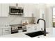 Modern kitchen details showcasing white cabinets, stainless steel appliances, and quartz countertops at 108 Isle Of Pines Rd # 3, Mooresville, NC 28117