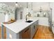 Angle view of the island kitchen with stainless dishwasher and hanging lamps at 108 Isle Of Pines Rd # 3, Mooresville, NC 28117