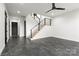 Open-concept living space with wood stairs, black railing and modern ceiling fan at 108 Isle Of Pines Rd # 3, Mooresville, NC 28117