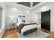 A bright main bedroom features hardwood floors, a modern bed, and ensuite bathroom access at 108 Isle Of Pines Rd # 3, Mooresville, NC 28117