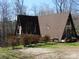 A-frame house with inviting front porch and surrounding greenery, blending architectural design with nature's beauty at 13062 Highway 55 W Hwy, York, SC 29745