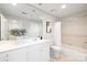 Bright bathroom features a modern vanity, neutral tile, and shower-tub combination at 1320 Fillmore St # 419, Charlotte, NC 28203