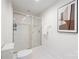 Bathroom featuring a glass enclosed shower, white tile, and a modern art piece on the wall at 1320 Fillmore St # 419, Charlotte, NC 28203