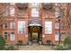 Exterior entrance to building with a covered awning, brick facade, manicured landscaping, and glass doors at 1320 Fillmore St # 419, Charlotte, NC 28203