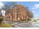 Brick condo building featuring multiple floors and pedestrian crosswalk in front on a cloudy day at 1320 Fillmore St # 419, Charlotte, NC 28203