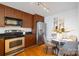 Kitchen and dining area featuring stainless steel appliances, wood cabinets, and a breakfast table at 1320 Fillmore St # 419, Charlotte, NC 28203