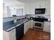 Well-lit kitchen featuring black countertops, stainless steel appliances, and white cabinets at 1320 Fillmore St # 419, Charlotte, NC 28203
