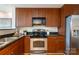 Kitchen featuring stainless steel appliances, dark countertops and wood cabinets at 1320 Fillmore St # 419, Charlotte, NC 28203