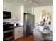 Efficient kitchen with stainless steel refrigerator, adjacent to a dining area with seating at 1320 Fillmore St # 419, Charlotte, NC 28203